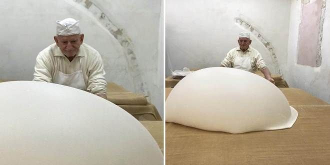 A man stands before a risen dough, his hands delicately shaping its form, capturing a moment of culinary artistry where creation and anticipation intertwine.